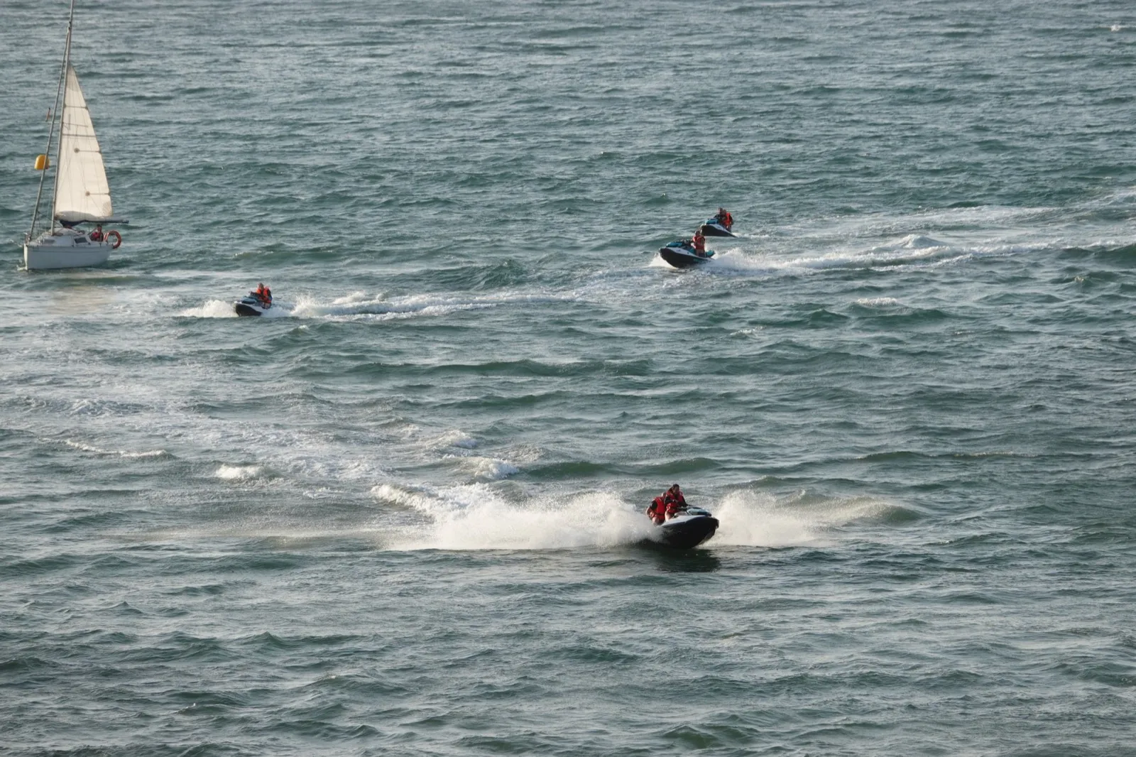 Cannonball riders on jet skis out in the bay at Ribadesella