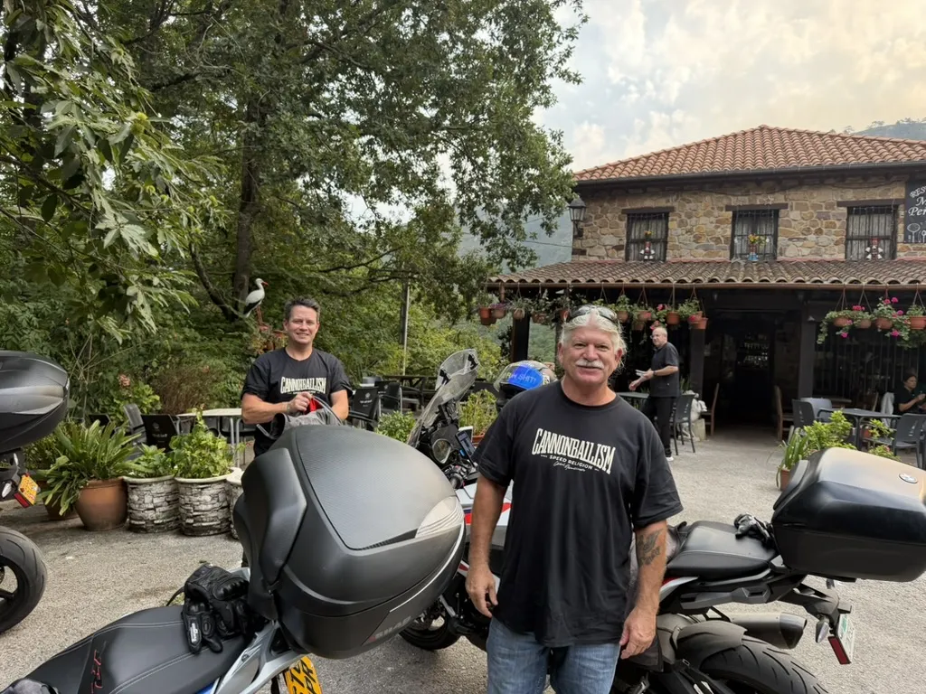 Kenny and Kenny, two American Cannonball riders, at a café stop beside their motorcycles