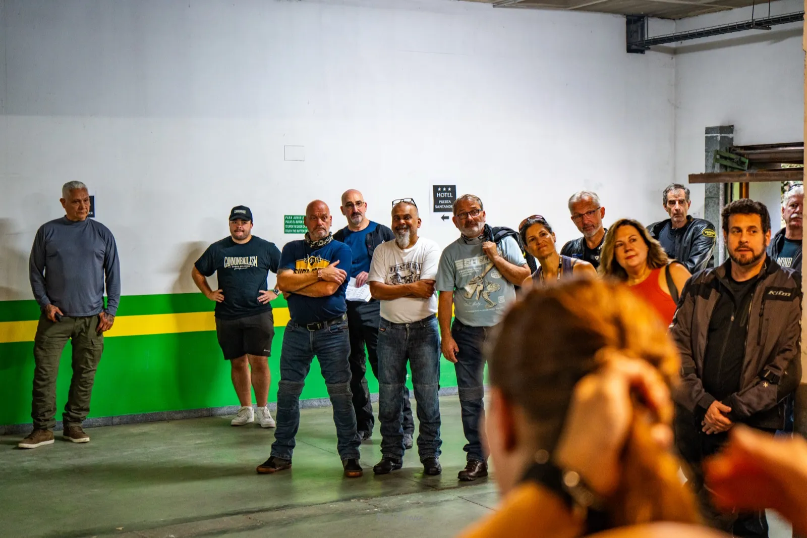 Cannonball riders listening to the morning briefing in the Santander hotel garage