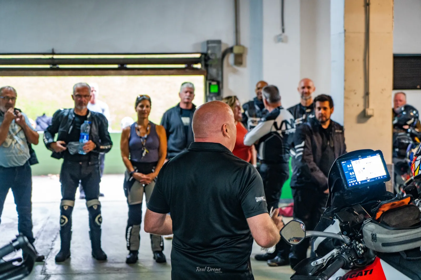 Riders gathered for the Cannonball Viberia safety briefing in the Santander hotel garage