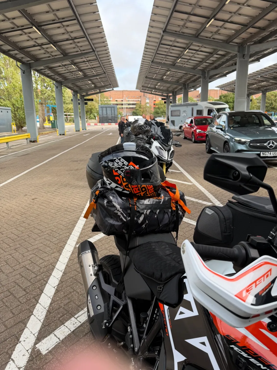 Loaded Cannonball motorcycles queuing under the canopies at the Portsmouth ferry terminal