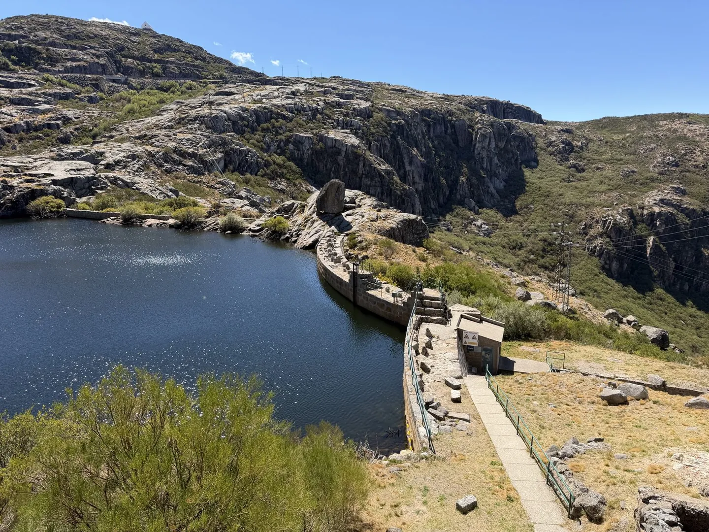Mountain reservoir and dam surrounded by granite rocks high in the Portuguese mountains