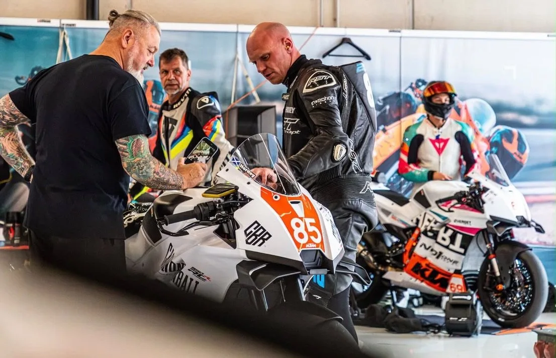 Alan Jones and Steven Horne with Steven's #85 KTM RC 990 R Cup race bike in the garage at the Red Bull Ring