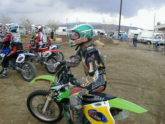 Jeremy Simmons on a green motocross bike preparing to start a race