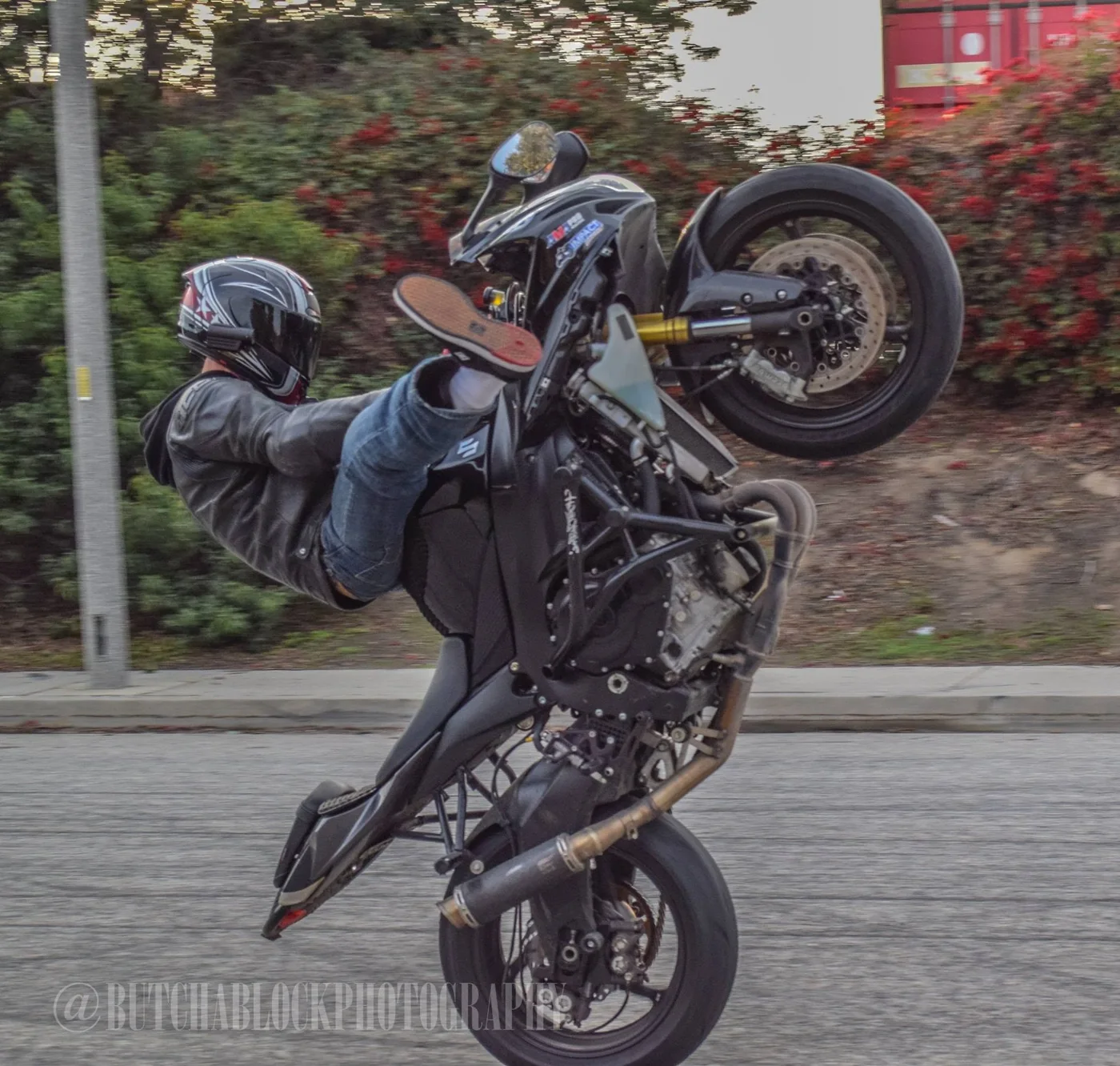 Jeremy Simmons riding a wheelie on a street bike