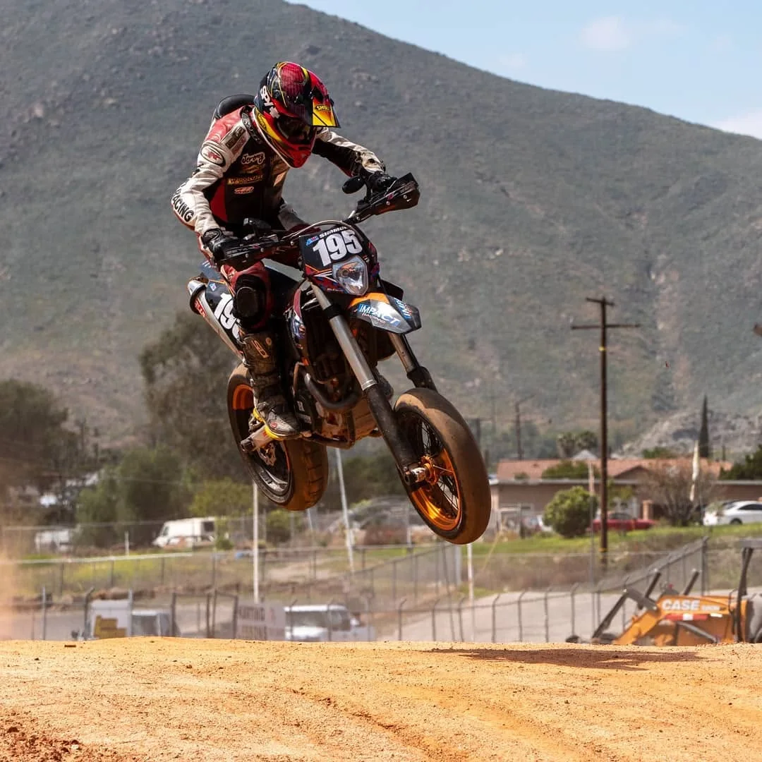 Jeremy Simmons jumping his supermoto bike high in the air