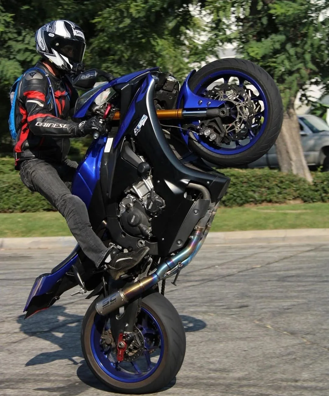 Jeremy Simmons pulling a wheelie on a blue Yamaha sports bike