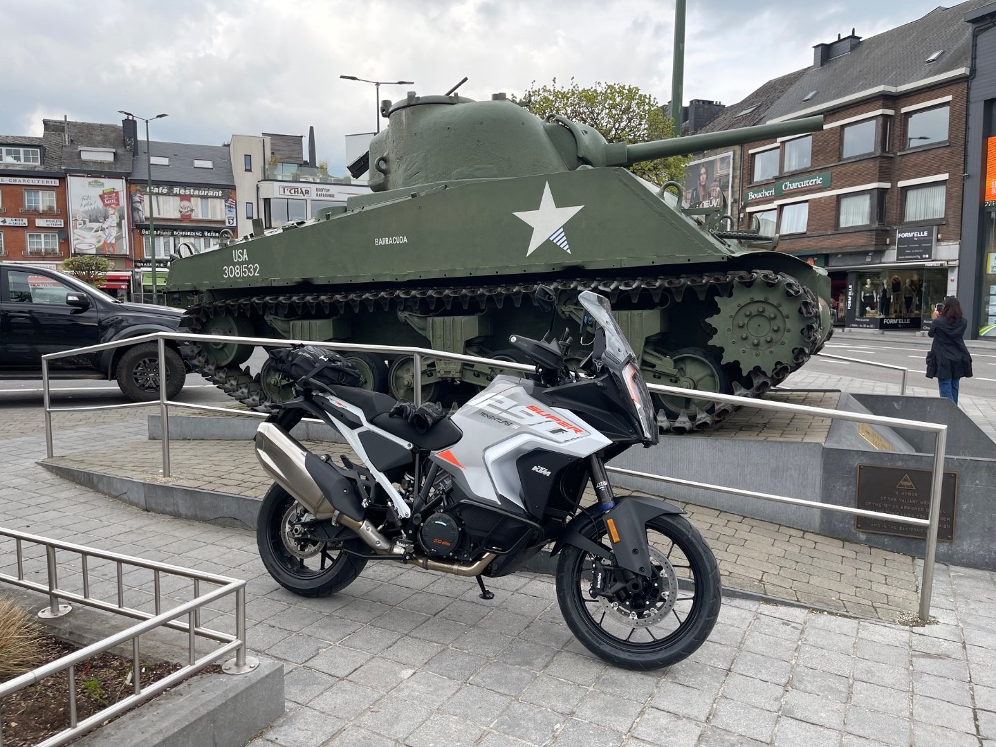 KTM 1290 Super Adventure parked beside the Sherman tank Barracuda on McAuliffe Square in Bastogne