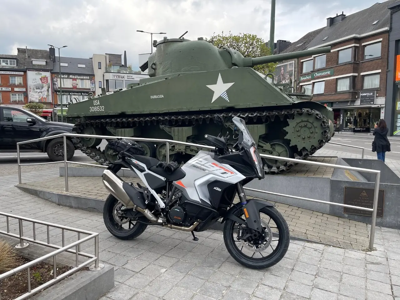 KTM 1290 Super Adventure parked beside the Sherman tank Barracuda on McAuliffe Square in Bastogne