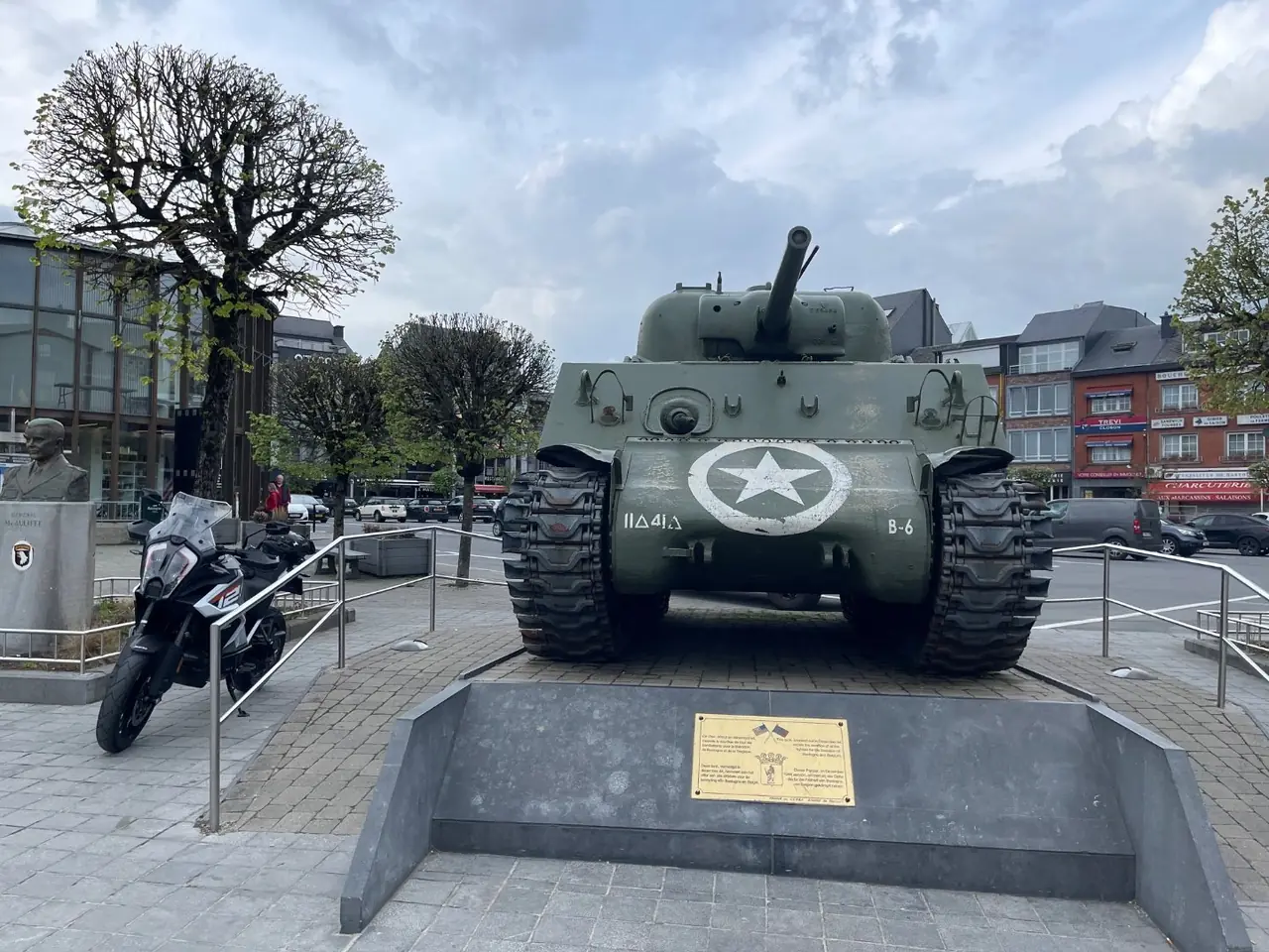 Front view of the Sherman tank Barracuda on McAuliffe Square in Bastogne with the McAuliffe bust to the left