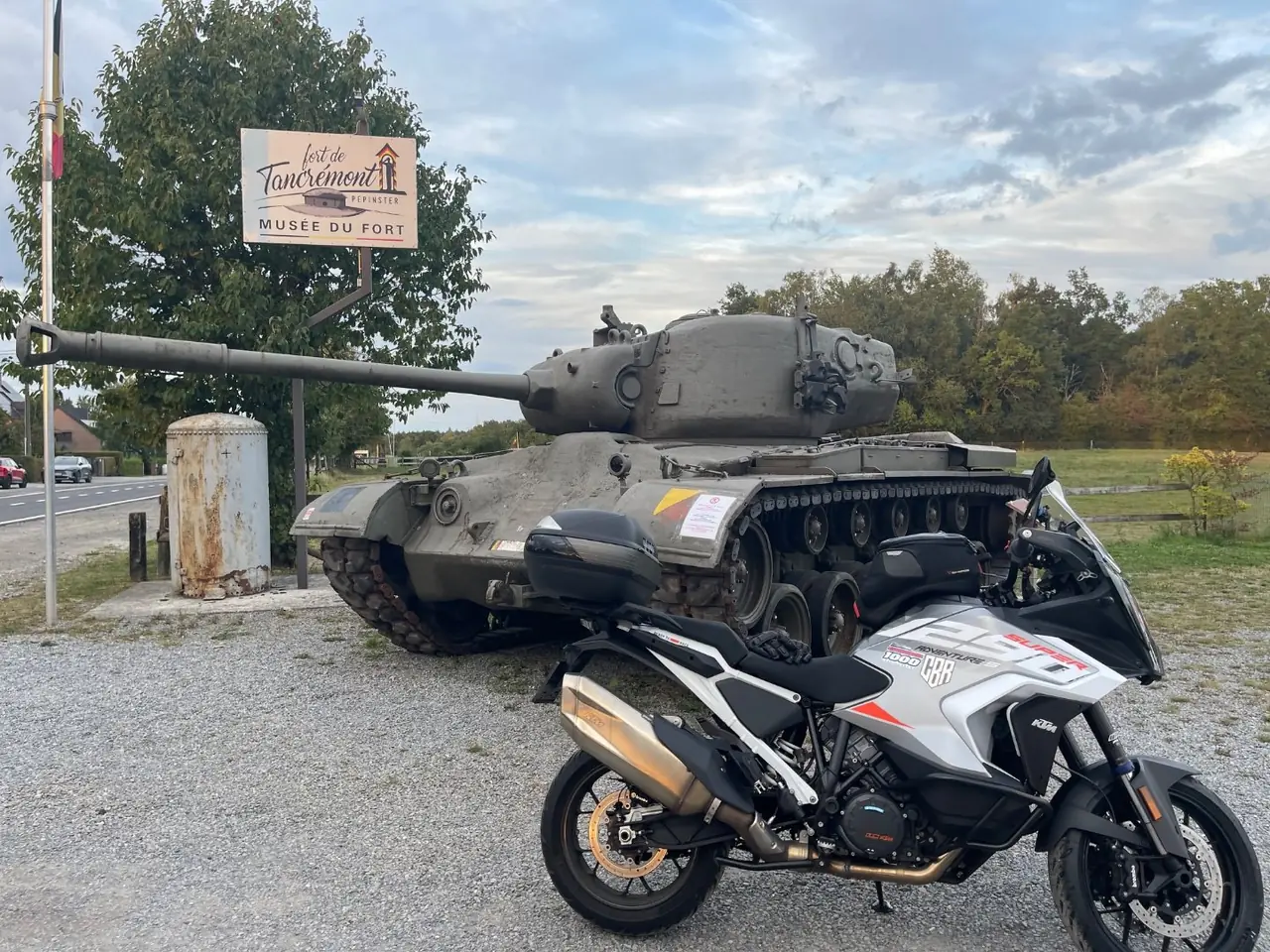 KTM 1290 Super Adventure parked in front of a tank at the Fort de Tancremont museum near Pepinster, Belgium
