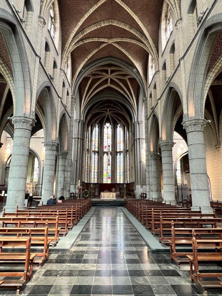 Inside the abbey church at Val-Dieu, looking down the nave towards the stained glass behind the altar