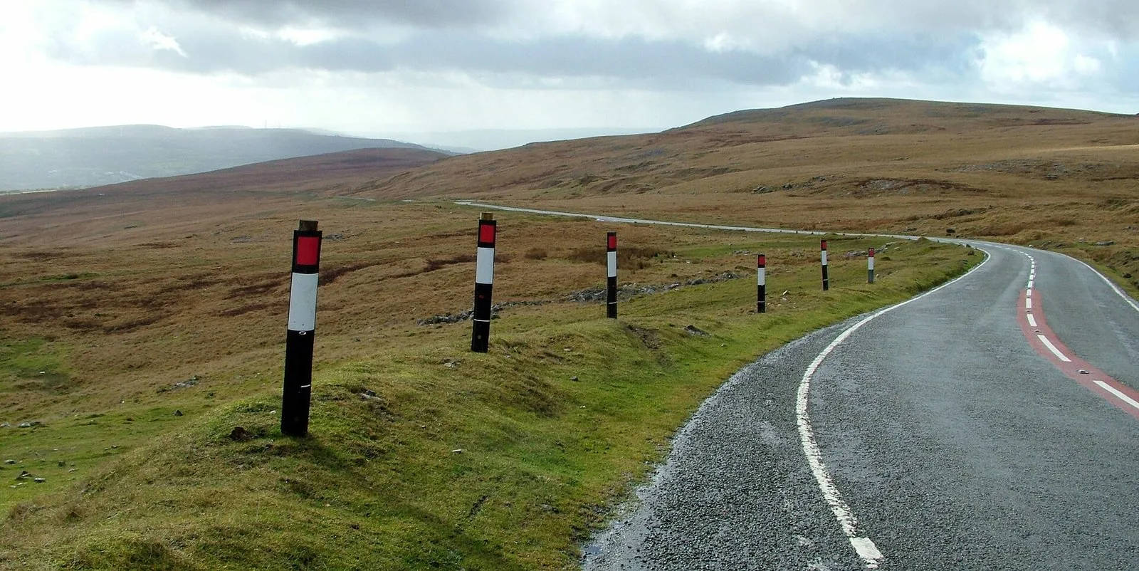 The A4069 Black Mountain Pass, red-and-white marker posts lining the tarmac as it curves across open moorland