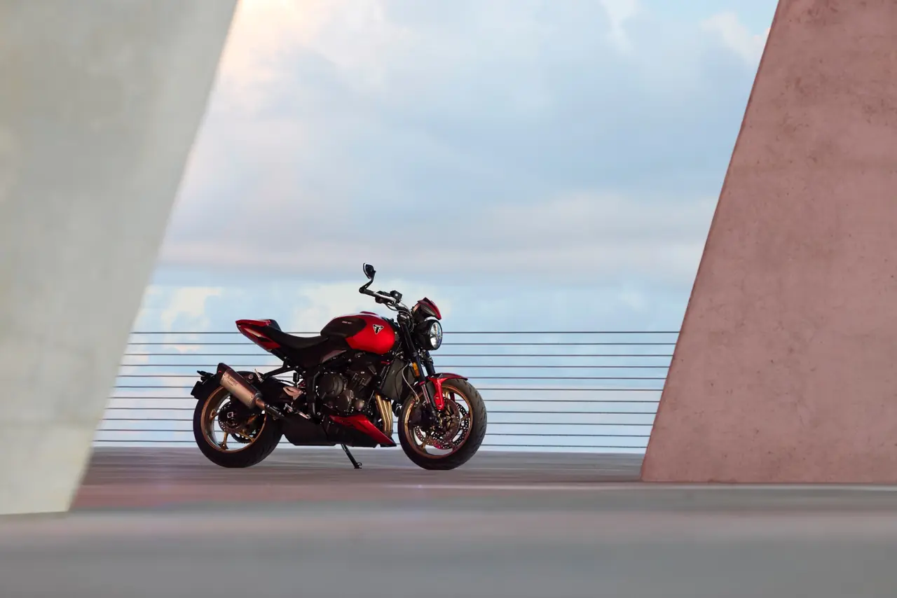 Real photo of the 2026 Triumph Trident 800 parked side-on in Carnival Red